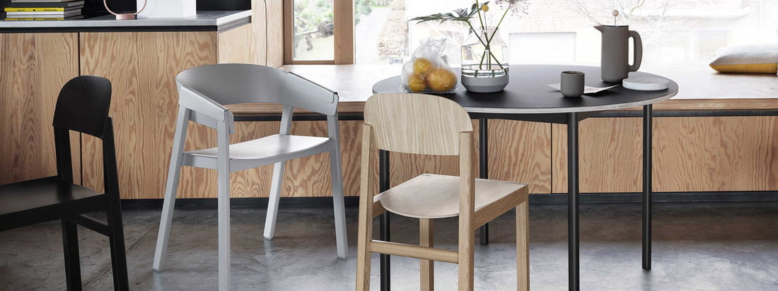The Muuto Cover chair made of wood with a black table and gray chair for the Japandi trend.