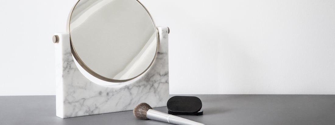 Ambient image of the Pepe marble mirror from Menu. The mirror presents itself in a timeless form and is ideal as a vanity mirror in the bathroom.