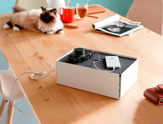 The Charge Box by Konstantin Slawinski in the ambience view: The box hides charging cables of iPhones, cameras and other devices stylishly on the kitchen table.
