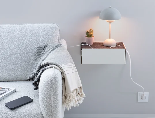 The Charge Box by Konstantin Slawinski in the ambience view: The box hides charging cables of iPhones, cameras and other devices stylishly on the kitchen table.