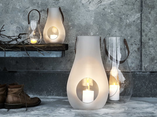 A prime example of stylish and beautiful gifts for women: the Design with Light lantern from Holmegaard made of transparent or matt white glass and a leather handle.