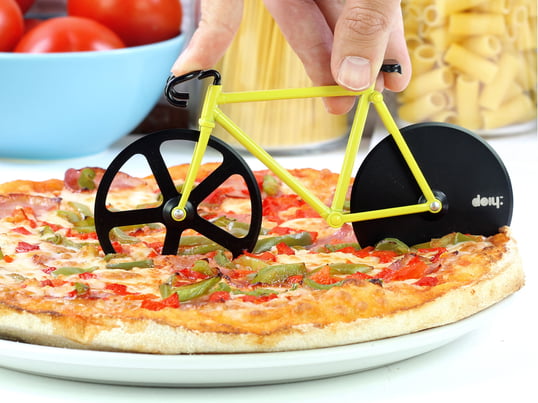 The cutter is a small bike, which is steered across the pizza, cutting it into pieces with its two blades.