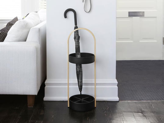 The Hub umbrella stand from Umbra in the ambience view: stick umbrellas can be conveniently stored in the Hub umbrella stand, while small pocket umbrellas can be attached to the Hub wall hook and left to drip dry.