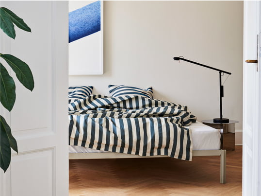 The Été bed linen by Hay in the ambience view: The bed linen brings the beautiful summer days and the fresh sea air into the bedroom with its soft, sun-bleached stripes.