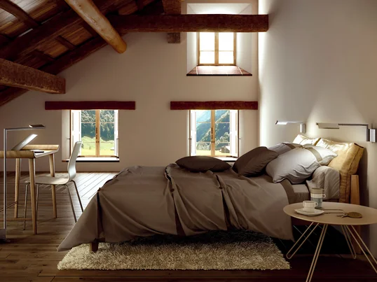 The lamp consists of a base with a swivel arm on which an adjustable lampshade is attached. The reading light is well above the bed.