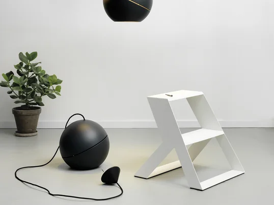 The Split Step stepladder by Frederik Roijé in white in the ambience view. The stepladder is ideal for mounting pendant lights on the ceiling.