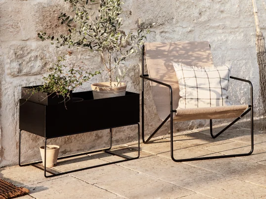 The Desert Chair from ferm Living in the ambience view: together with the Plant Box, the filigree chair creates a cozy atmosphere for relaxing on the patio.