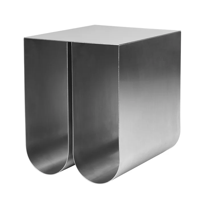 Curved side table by Kristina Dam Studio in stainless steel