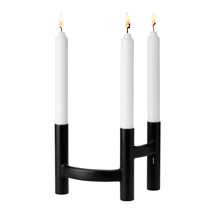 The candlestick three-armed of Stelton with burning candles