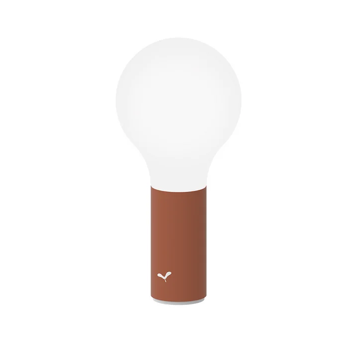 The Aplô outdoor lamp from Fermob , H 24 cm, ocher red