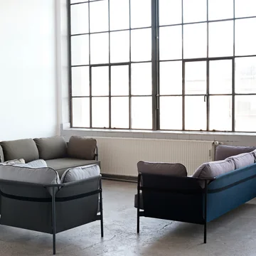Can sofa, 3-seater and armchair group arranged by HAY to form a seating area