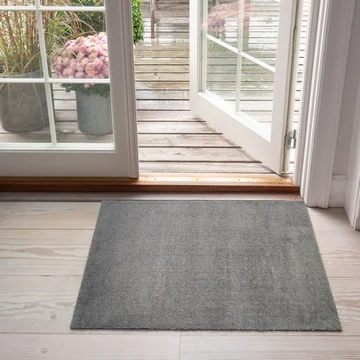 The Unicolor doormat from tica copenhagen in front of the patio door
