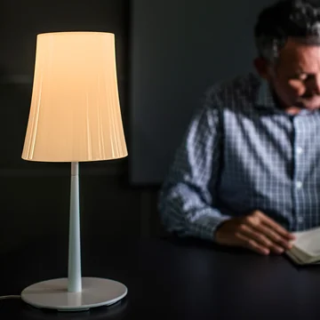 The Birdie Easy table lamp from Foscarini with its glowing, translucent shade