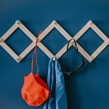 The Lia wall wardrobe from side by side on a blue wall with swimming gear