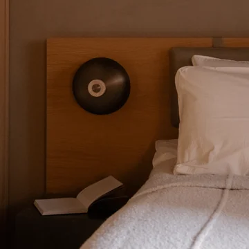 Audo - Reverse LED wall light, Ø 24 x H 15.5 cm, burnished brass / travertine stone (hard-wired)