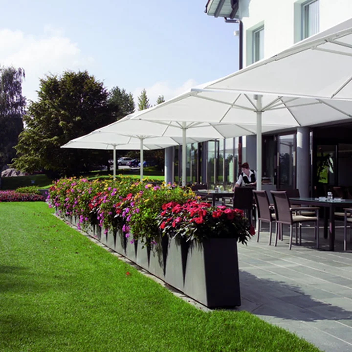 The Twista Plant pot from Eternit on a large stone terrace