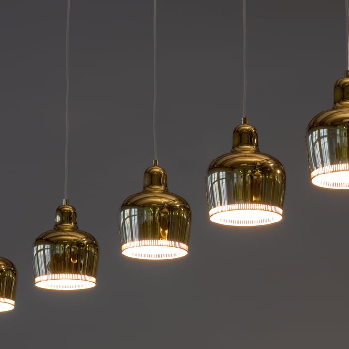 The luminous A 330S Golden Bell pendant lights by Artek