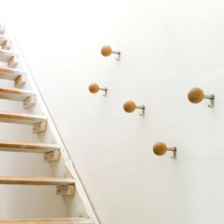 The Schönbuch - Dots wall hooks in natural wood as a coat rack in the staircase