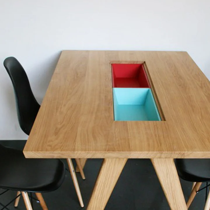 The Remix Collection Dining Table by The Hansen Family with colourful compartments in the middle