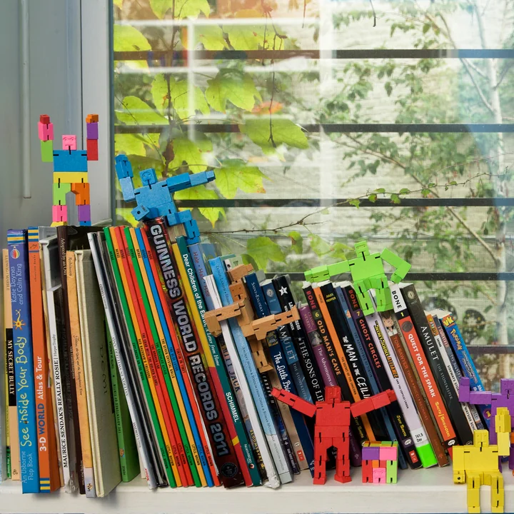 The Cubebot from Areaware as decoration on books