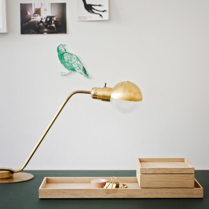 The Nomad Box from Skagerak on a dark green desk