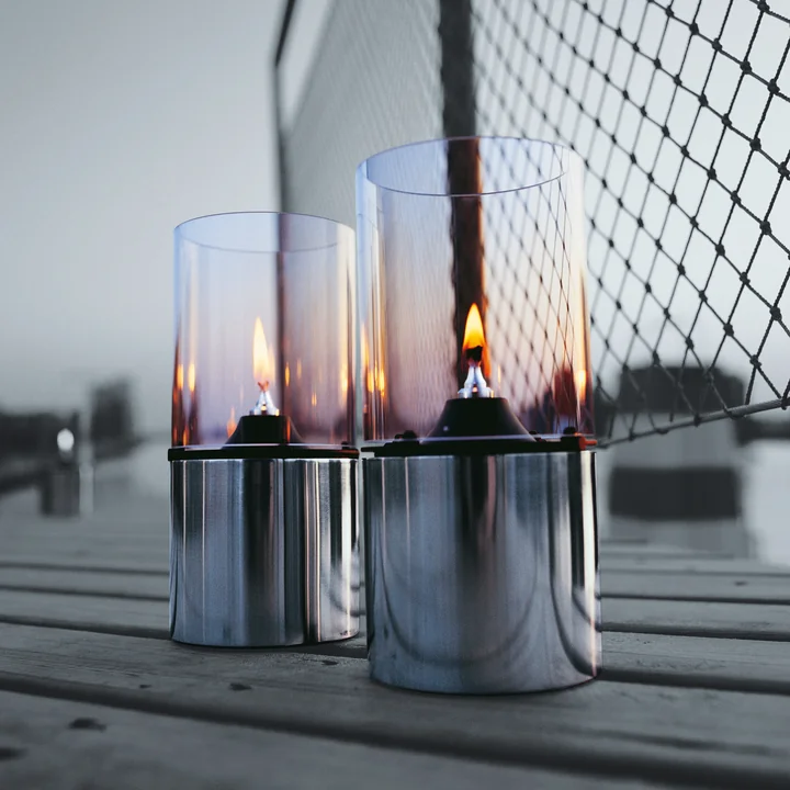 The noble oil lamps from Stelton on a wooden walkway