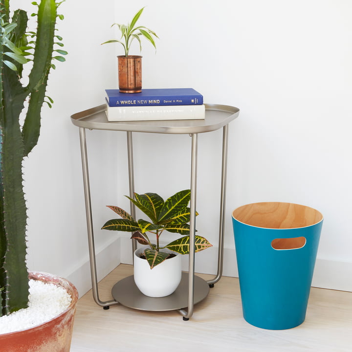 The Umbra - Woodrow Waste Paper Bin in Blue Next to a Side Table