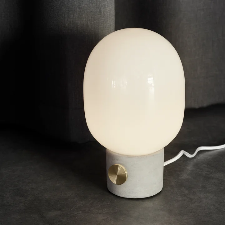 The Audo - JWDA Concrete Table Lamp, Light Grey / Brass on the Floor