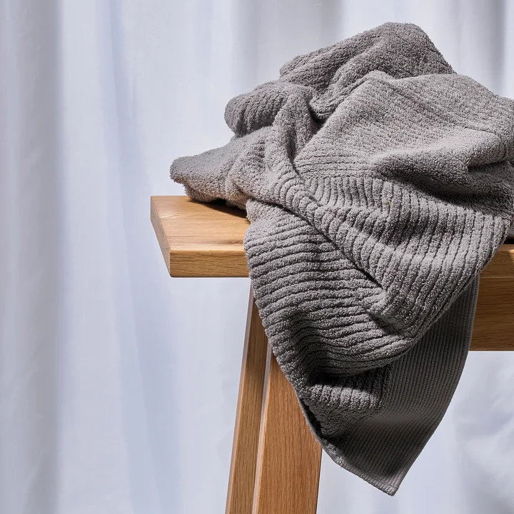 The Zone Denmark - Classic Towel, gray on a wooden bench