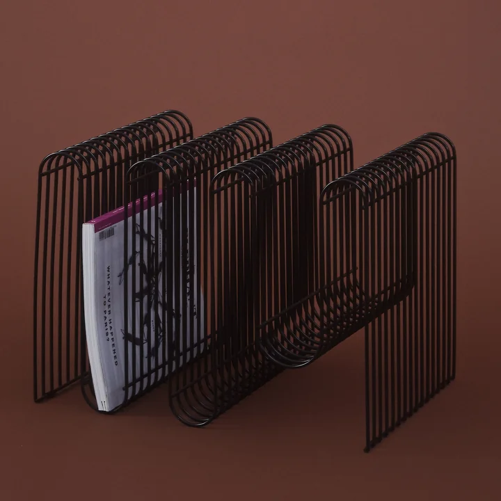 Curva Magazine holder in black from AYTM with newspaper