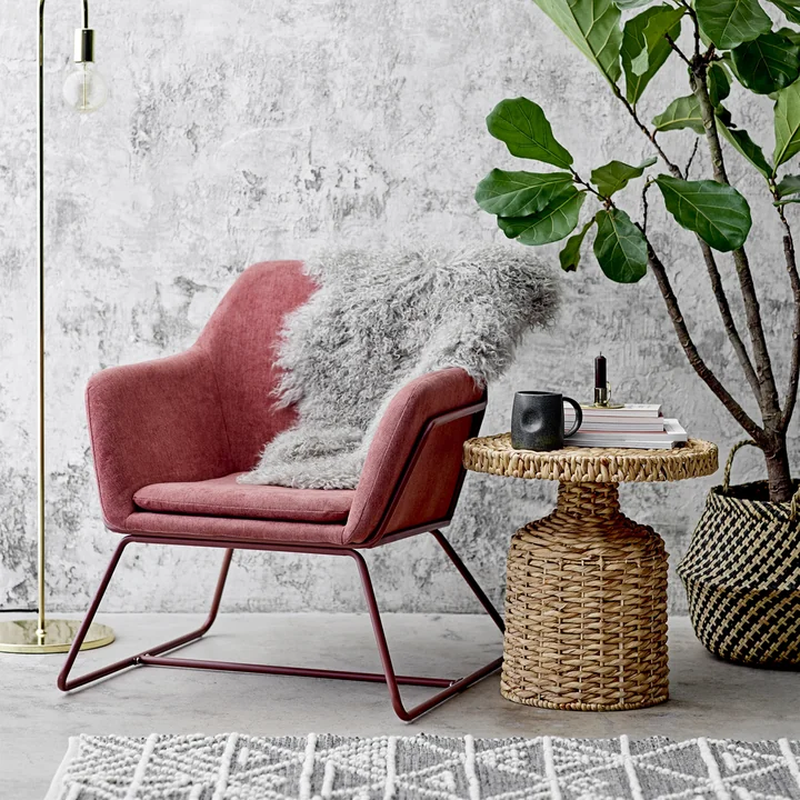 Camo side table woven by Bloomingville, Ø 47 x H 47 cm in nature next to the armchair