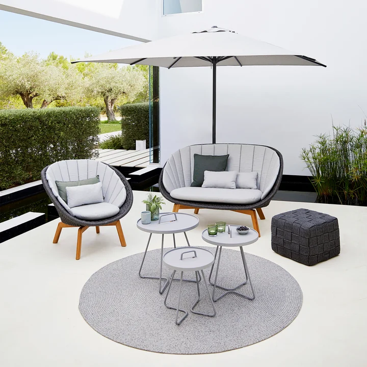 Peacock Lounge chair (5458) in teak / dark gray with Cube stool (8340) of Cane-line