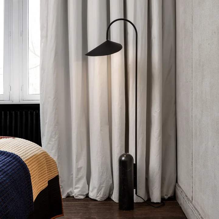 Arum floor lamp in black from Ferm Living in the bedroom
