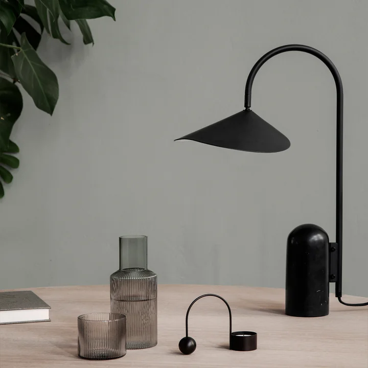 Arum table lamp in black from Ferm Living on the table 
