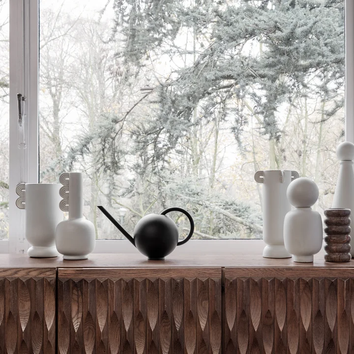 Orb watering can and Muses vase from Ferm Living on the windowsill