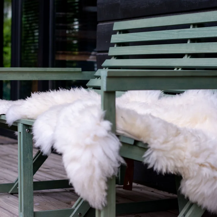 Sheepskin from Weltevree on a green garden bench 