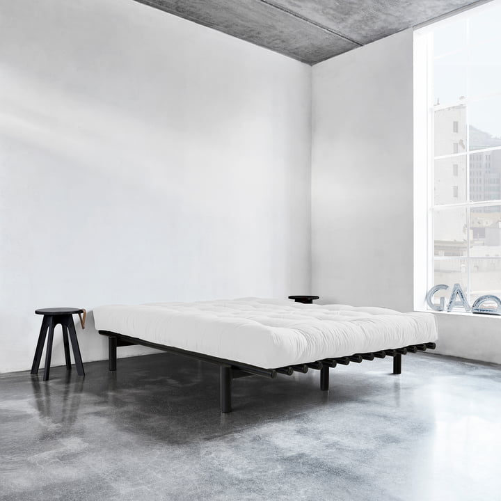 Pace bed by Karup Design with stool next to the bed