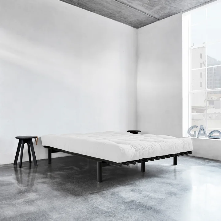 Pace bed by Karup Design with stool next to the bed