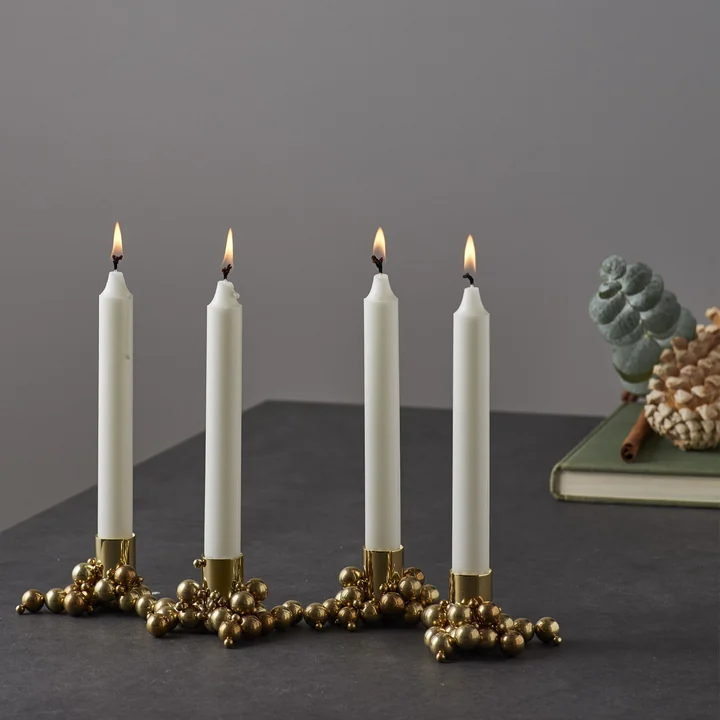 Molekyl candle holder 4 in brass by Gejst on the table 
