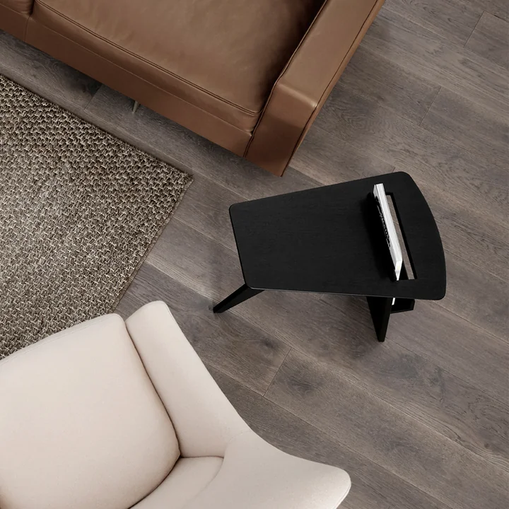 Risom magazine side table in oak black lacquered by Fredericia next to sofa and armchair
