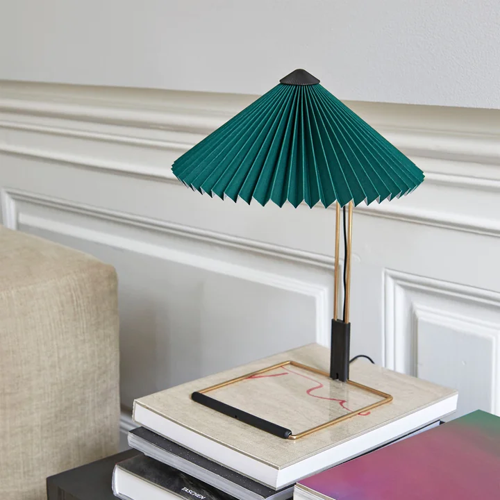 Matin LED table lamp S, green from HAY on the sideboard