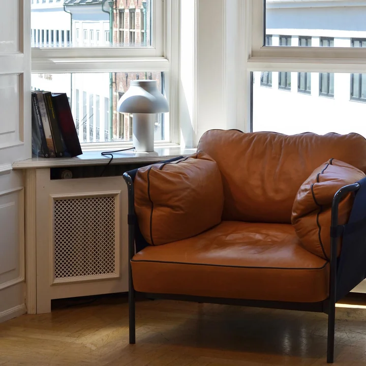 PC table lamp on the windowsill next to the Can armchair by HAY