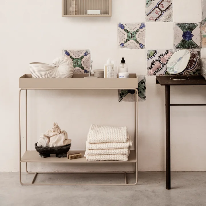 The Plant Box by Ferm Living with 2 levels in cashmere with towels, bathroom accessories and an artistic vase.