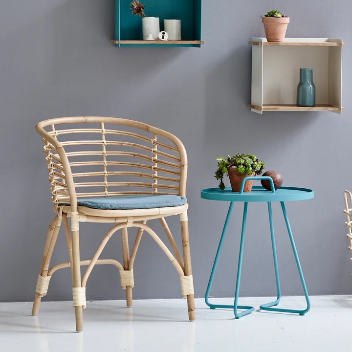 Blend indoor armchair and On-the-move side table from Cane-line