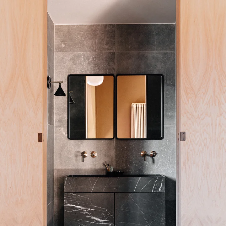 Norm wall mirror, black from Audo in the bathroom