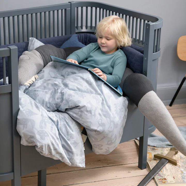 The Sebra bed Baby & Junior from Sebra in forest lake blue and pillow "Sleeping crocodile"