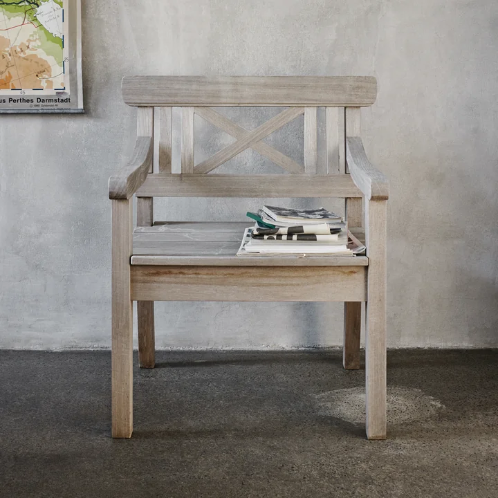 The Drachmann chair from Skagerak made of teak with magazines on the seat