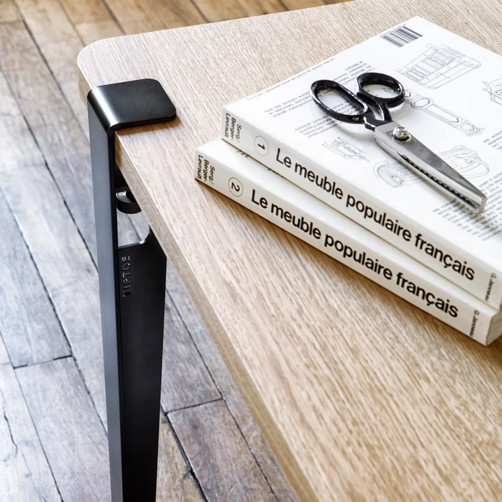 The table and desk leg, graphite black from TipToe at a work table with books and scissors
