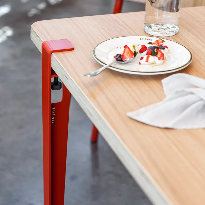 The table and desk leg, tomato red from TipToe at a dining room table