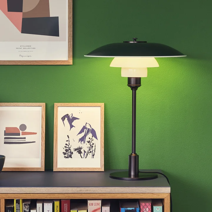 The PH table lamp, black from Louis Poulsen on a bookshelf